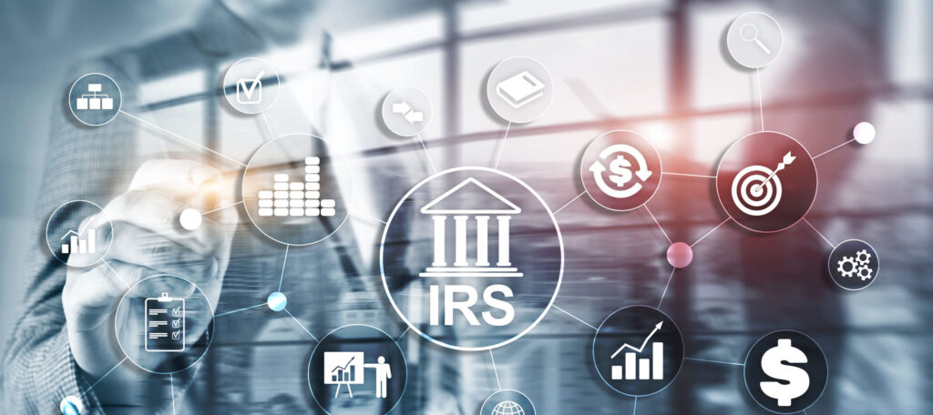 A person interacts with a virtual interface featuring interconnected financial icons, including graphs, target symbols, and a central icon labeled "IRS," underscoring the IRS warnings. The background is a blurred office scene with large windows.