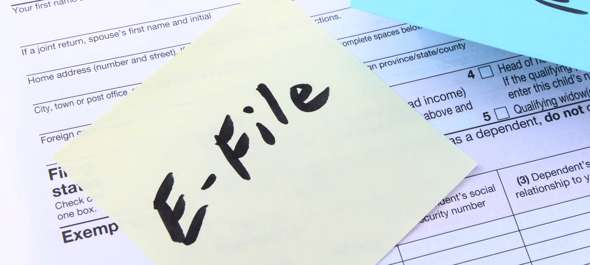 photo of tax return with post-it note on which is written "E-File" in black marker